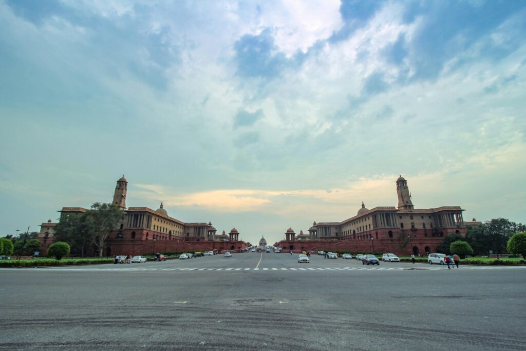A panoramic view of the Secretariat Buildings in New Delhi, India, under a clear sky.